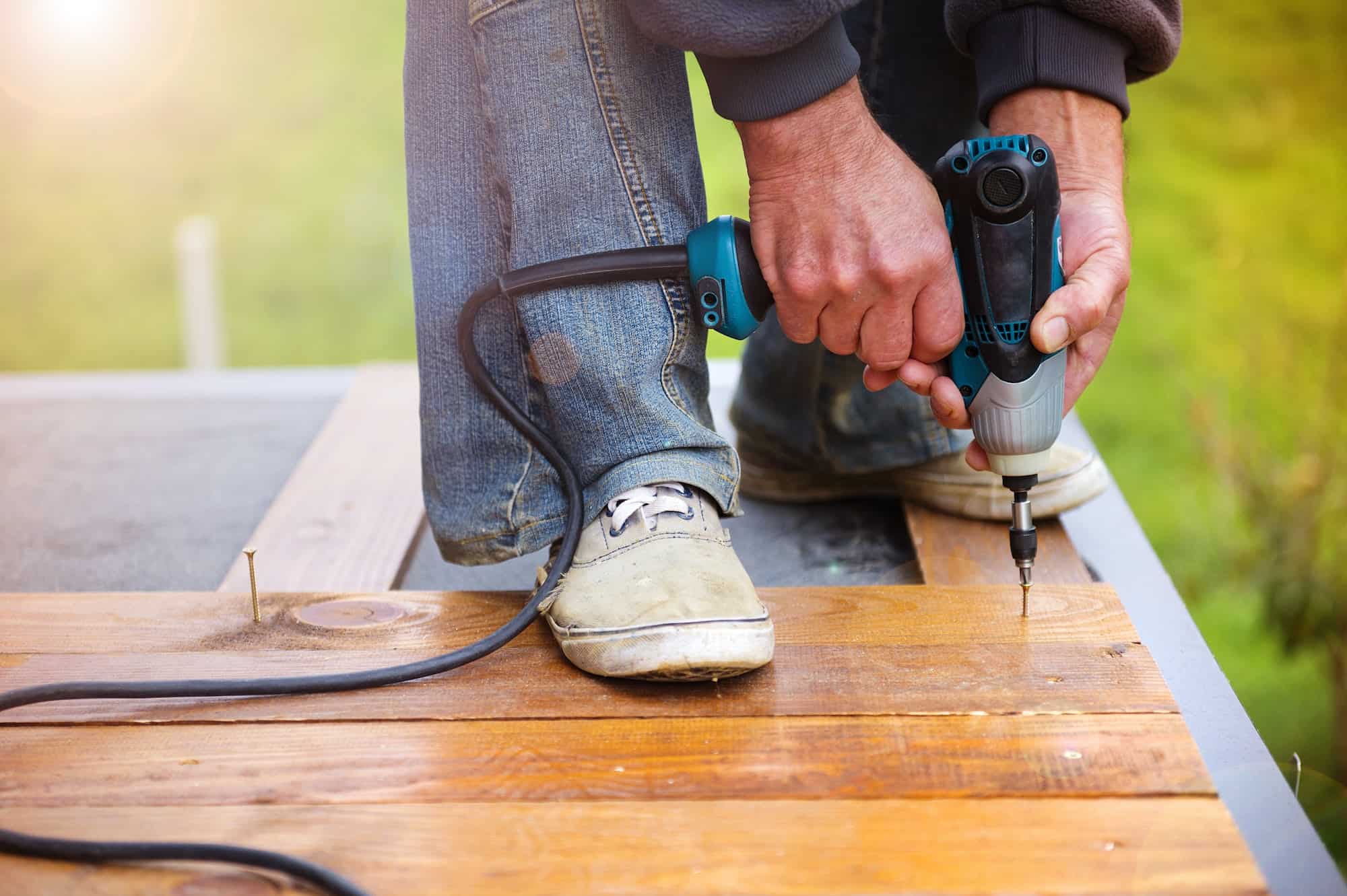 Handymen installing wooden flooring